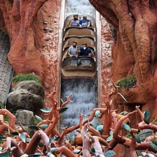 A log-flume rider being splashed by water.