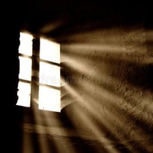 A bright ray of sunlight passing through a window.
