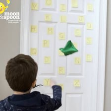 A person attaching a note to a wall.