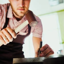 A person using a tool to accomplish a task.