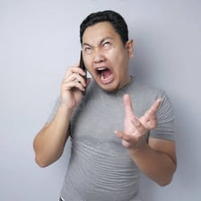 A person reacting with mild surprise during a conversation.