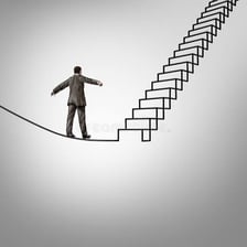 A person moving upward on a staircase.
