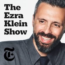Ezra Klein recording or presenting a podcast.
