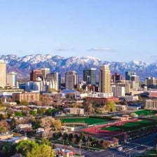 The skyline of Salt Lake City, Utah, with mountains in the background.
