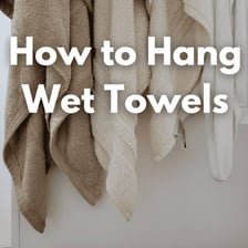 Bath towel hanging after use and appearing slightly damp