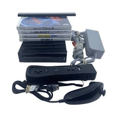 A Nintendo Wii console beside a Wii Remote and Nunchuk controller.