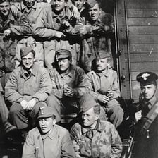 Soldiers from allied forces stand together.
