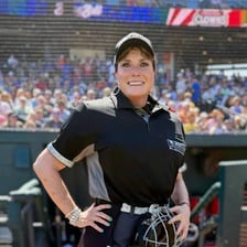 A baseball umpire standing on a baseball diamond