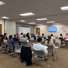 A small committee gathered around a conference table