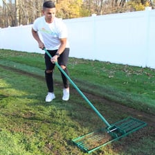 A worker leveling an uneven surface.