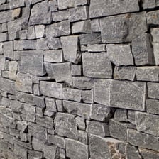 A close-up of dark gray slate stone
