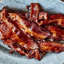 Crisp bacon strips coated or served with sweet maple flavor