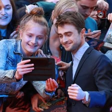 A celebrated performer being admired by a crowd of fans