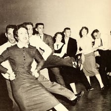 People dancing in a conga line