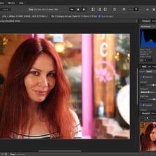 A person adjusting the color and lighting of a photograph on a computer.