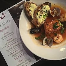A printed menu resting on a bistro table.