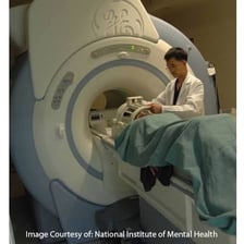 A patient undergoing an MRI scan in a cylindrical scanner
