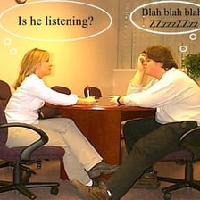 A person attentively listening to someone and showing concern.