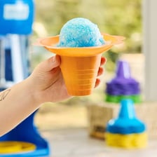 A colorful sno-cone served in a paper cup