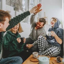 People talking together over cups of tea.