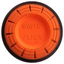 A clay target flying above a skeet-shooting range.