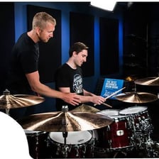 A musician playing a steady beat on a drum