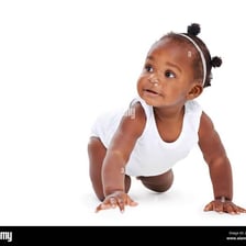 A baby moving across the floor on hands and knees.
