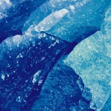 Blue-white ice forming part of a glacier.