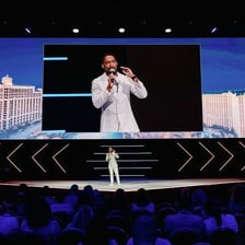 A presenter introducing the next part of an event