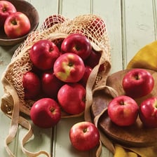 Red McIntosh apples gathered in a basket.