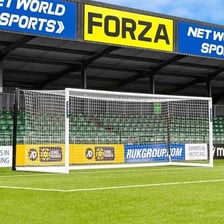 A marked soccer field with goals in a stadium