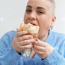 A person eating a gyro sandwich
