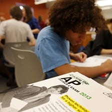 High-school students taking an exam in a classroom.