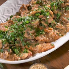 A plate of veal Marsala with mushroom sauce