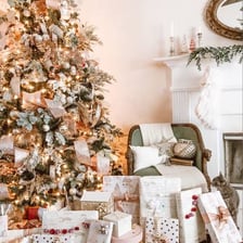 Wrapped presents arranged beneath a decorated Christmas tree.