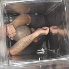 A person crawling through a narrow ventilation duct.
