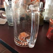 A glass of water beside food at a Mexican taqueria.