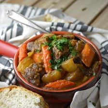 A pot of stew with vegetables and meat.