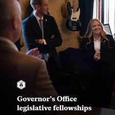 A government staff aide working beside an official.