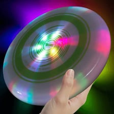 A glowing frisbee in flight against a dark background.