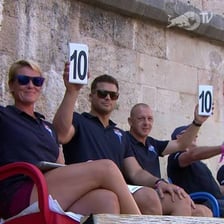 A competitive diver being awarded a perfect score.