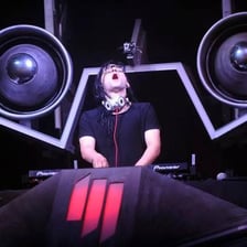 A DJ performing dubstep music at a live event.