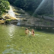 A swimmer in a lake near the shore.