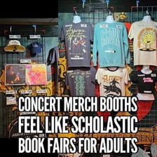 A merchandise table displaying T-shirts for sale.