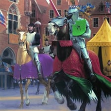 A medieval knight jousting on horseback
