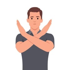 A person crossing their arms to signal refusal.