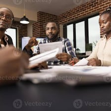Coworkers gathered around a conference table for a meeting