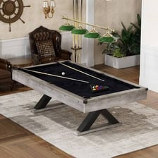 Billiards cues resting beside a pool table