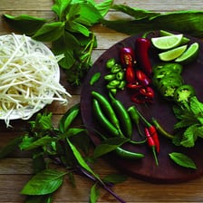 Mung beans and bean sprouts served alongside a bowl of Vietnamese pho.