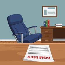 An unoccupied desk and chair in a workplace.